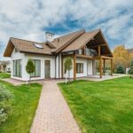 Contemporary house with a beautiful exterior and spacious lawn, set in a suburban area.
